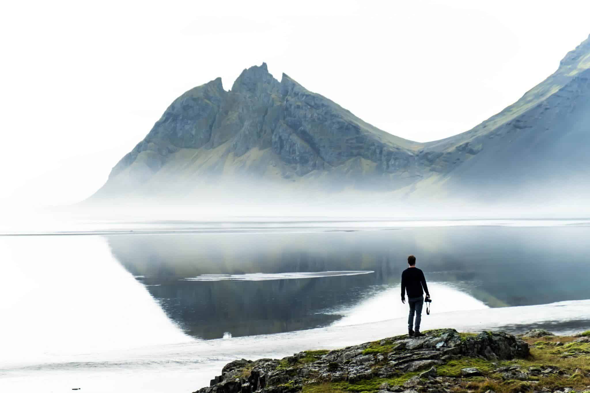 Cameron Stands Along The Moody Icelandic Coastline
