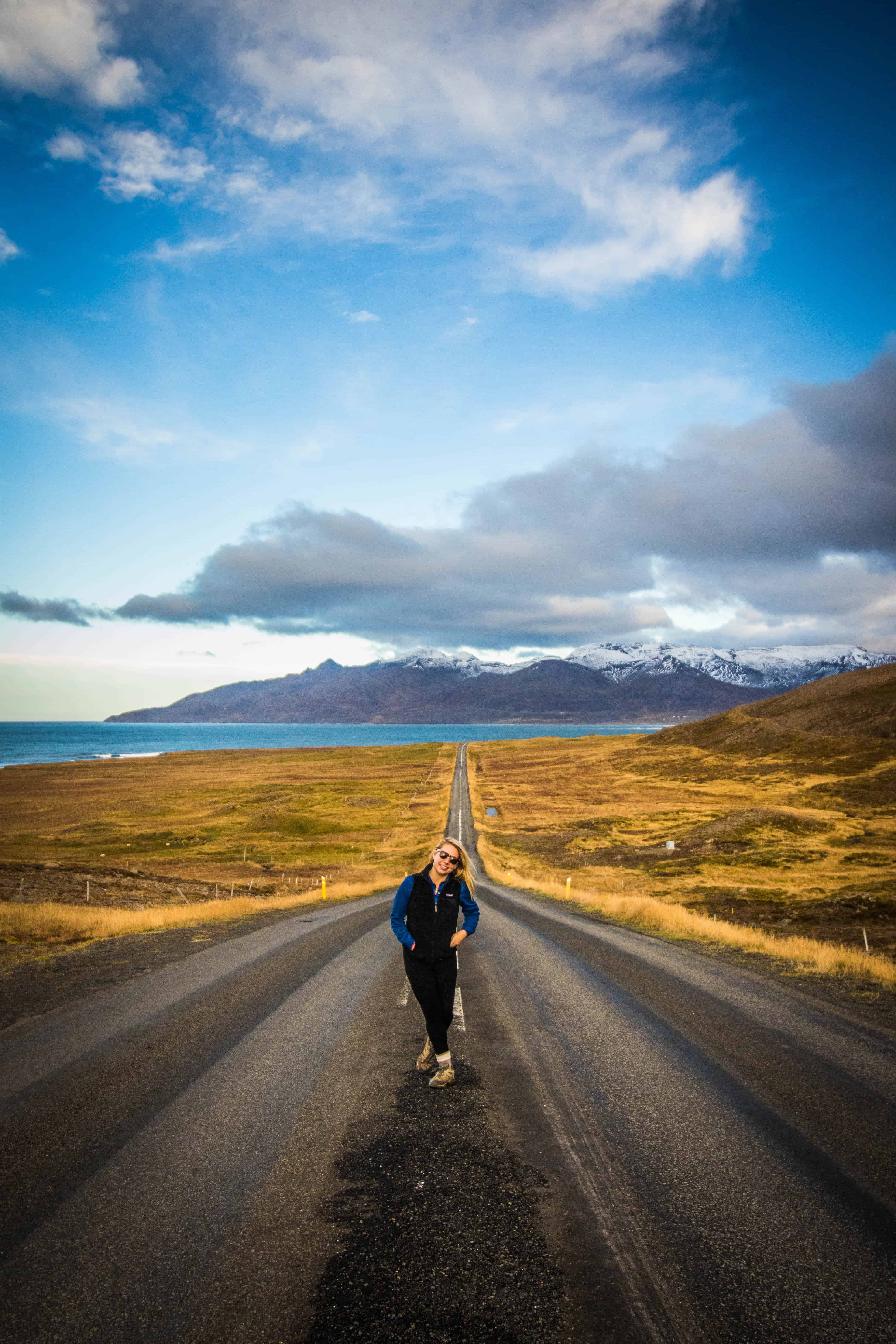 Natasha Walks Down Road In Iceland On Sunny Fall Day
