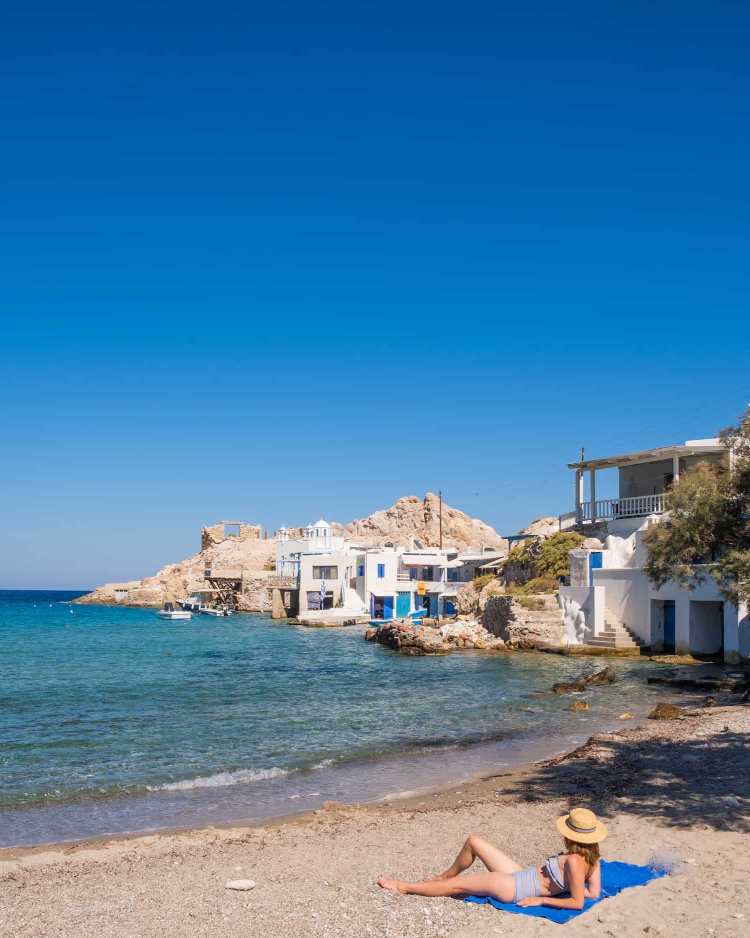 A Woman Sits On Firopotamos Beach