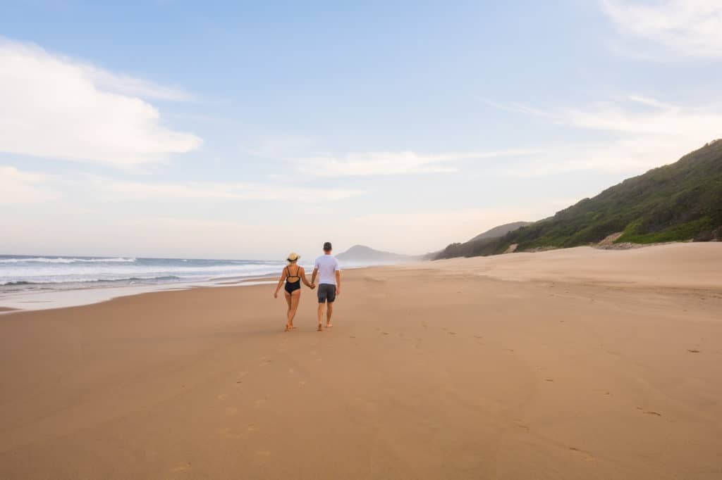 Cameron And Natasha Walk Along Beach In Mozambique
