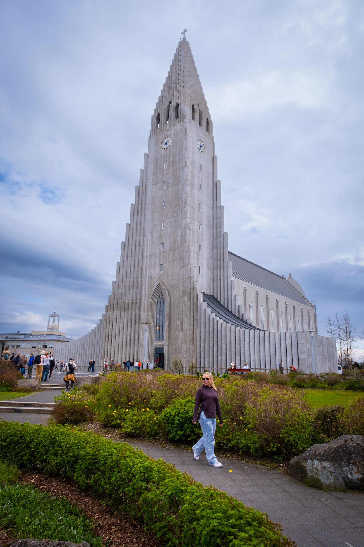 Natasha Walks In Front Of Hallgrimskirkja On Sunny Day