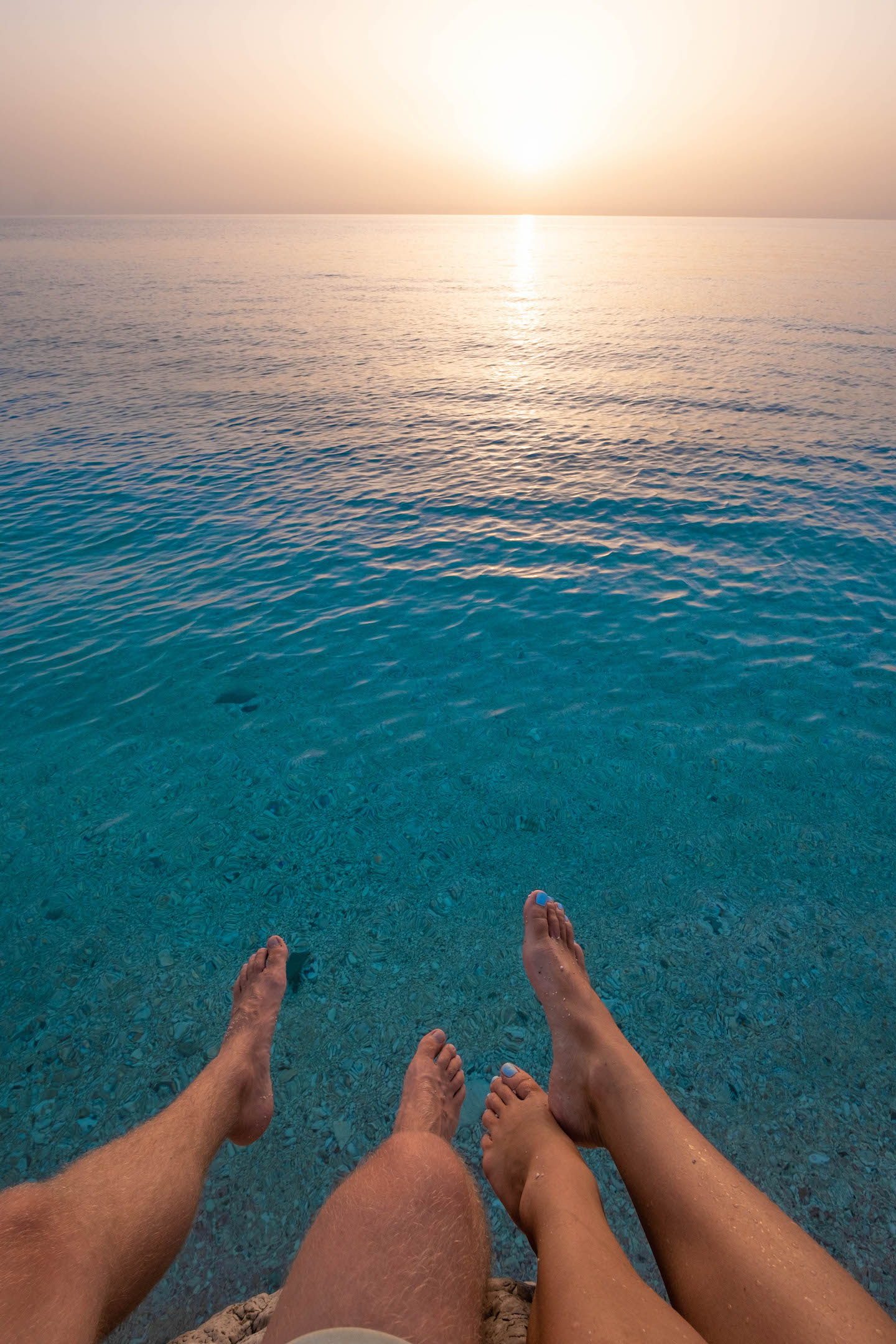 Cameron And Natasha's Feet Over Paralia Afales, Ithaca In Late Evening